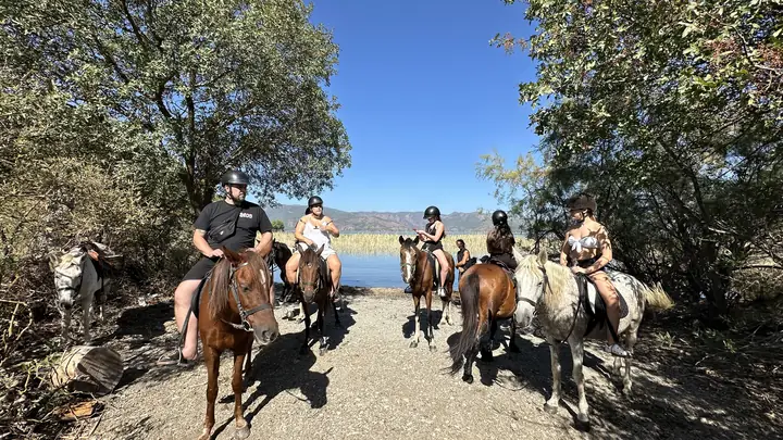 A group pause, lake beyond